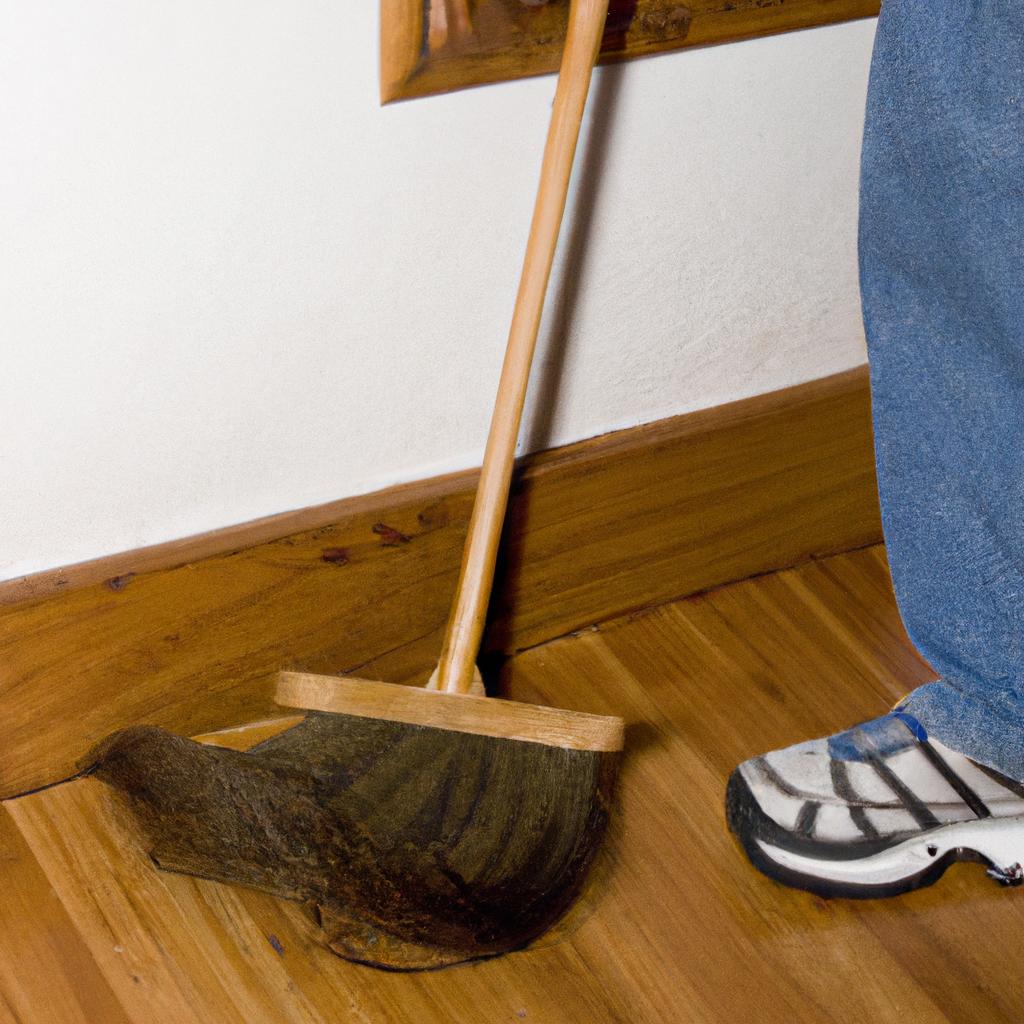 Sweeping cobwebs off the baseboard prevents spiders from crawling back up.